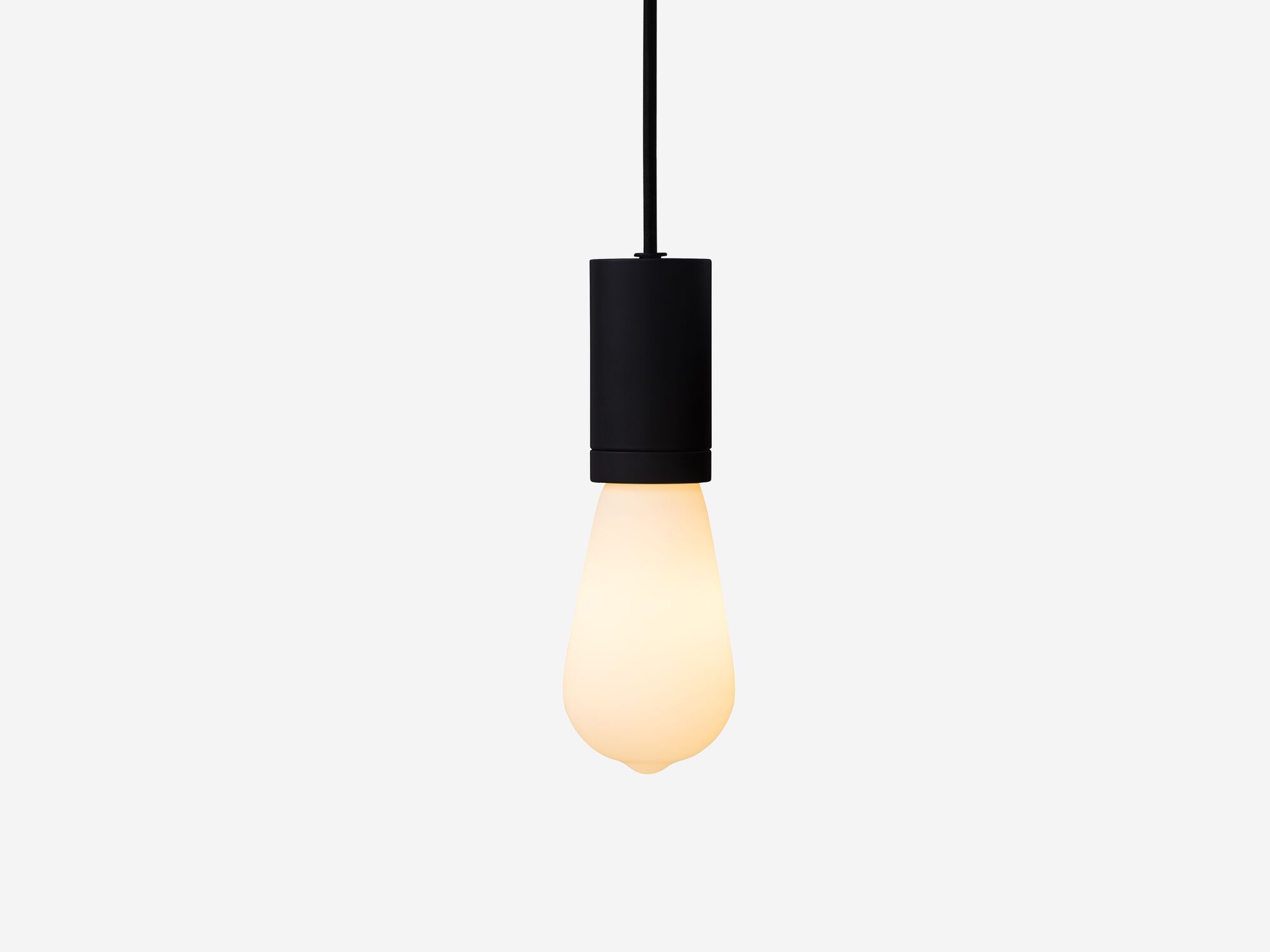 Front view of medium matte white lightbulb hanging from black hardware